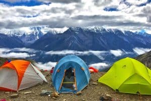 three tents on a plateau in the mountains