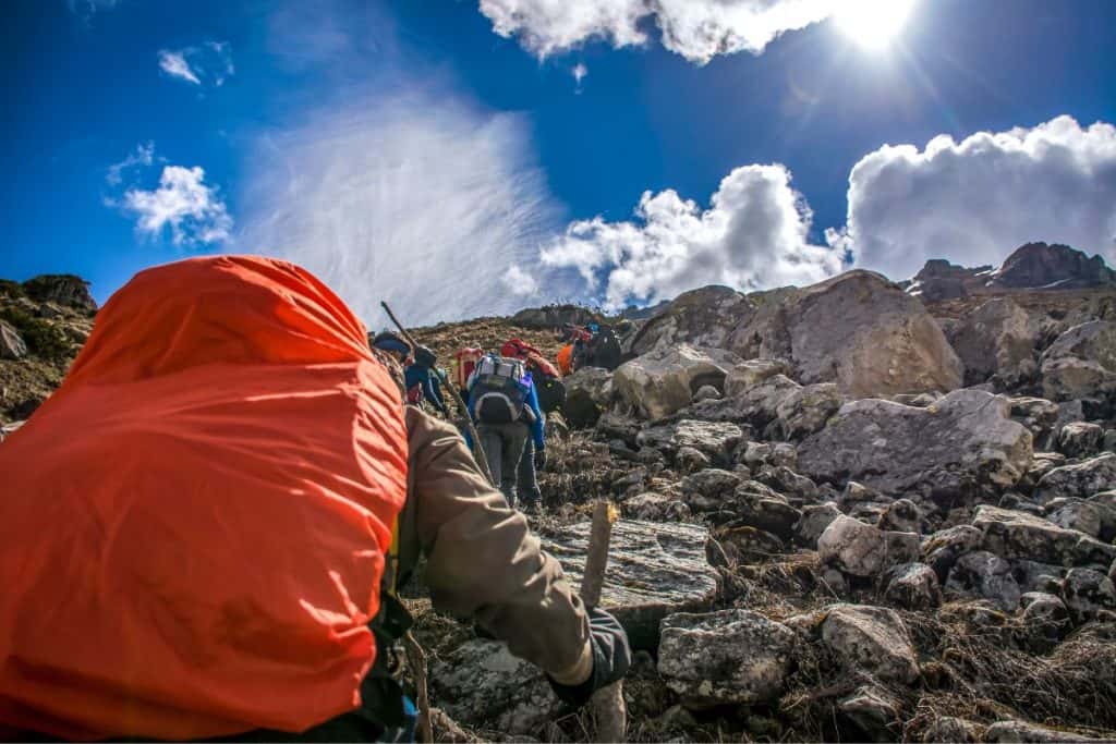 group of people hiking up a mountain