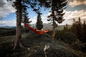woman lying in a hammock between two trees