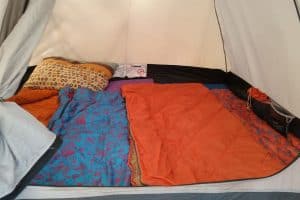 an orange and blue sleeping bag inside a tent