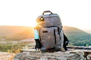 gray backpack sitting on a rock