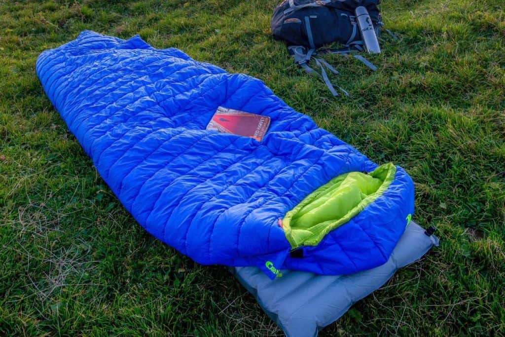 blue sleeping bag on the ground