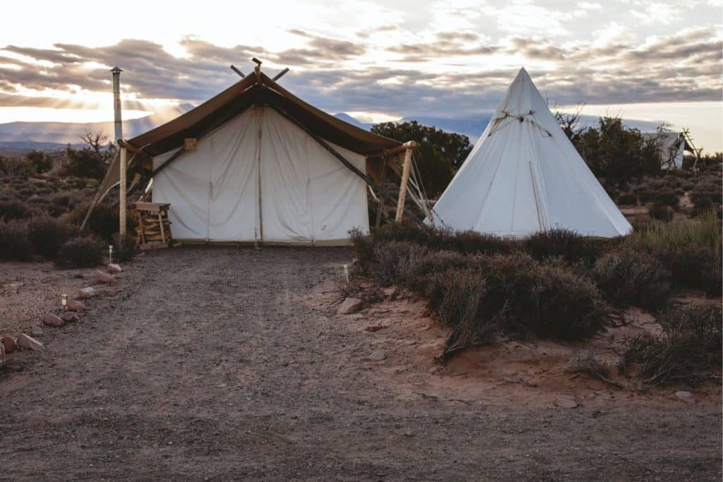 cabin and bell tent next to each other outside