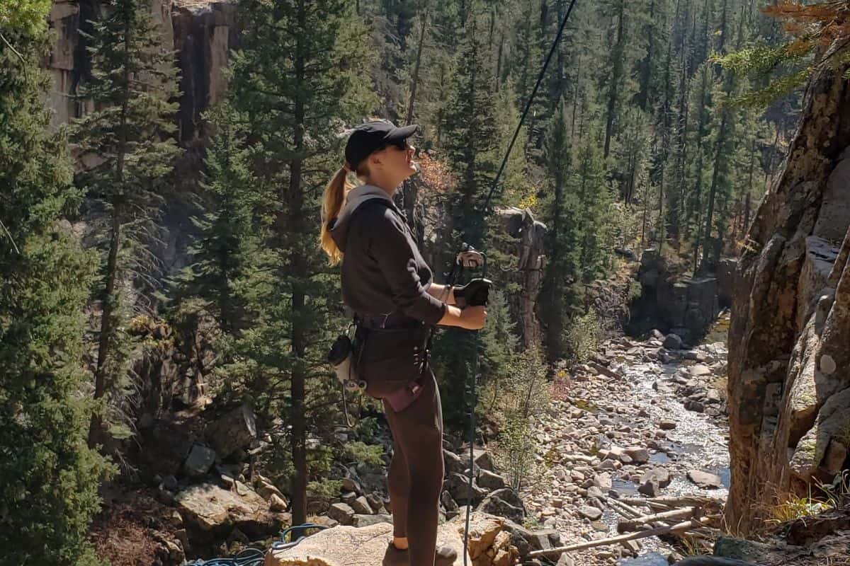 woman belaying while rock climbing