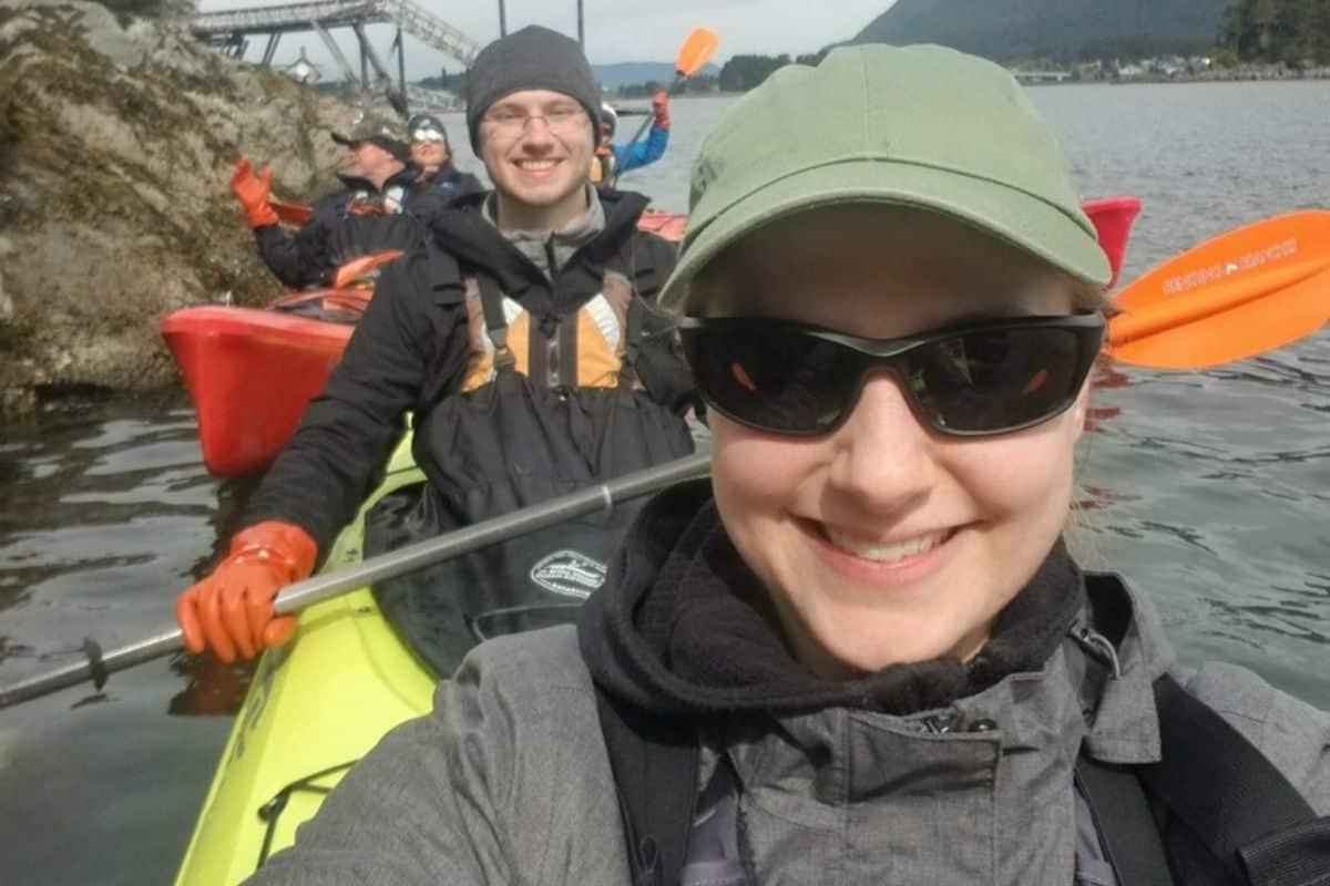 man and woman in a kayak on the ocean