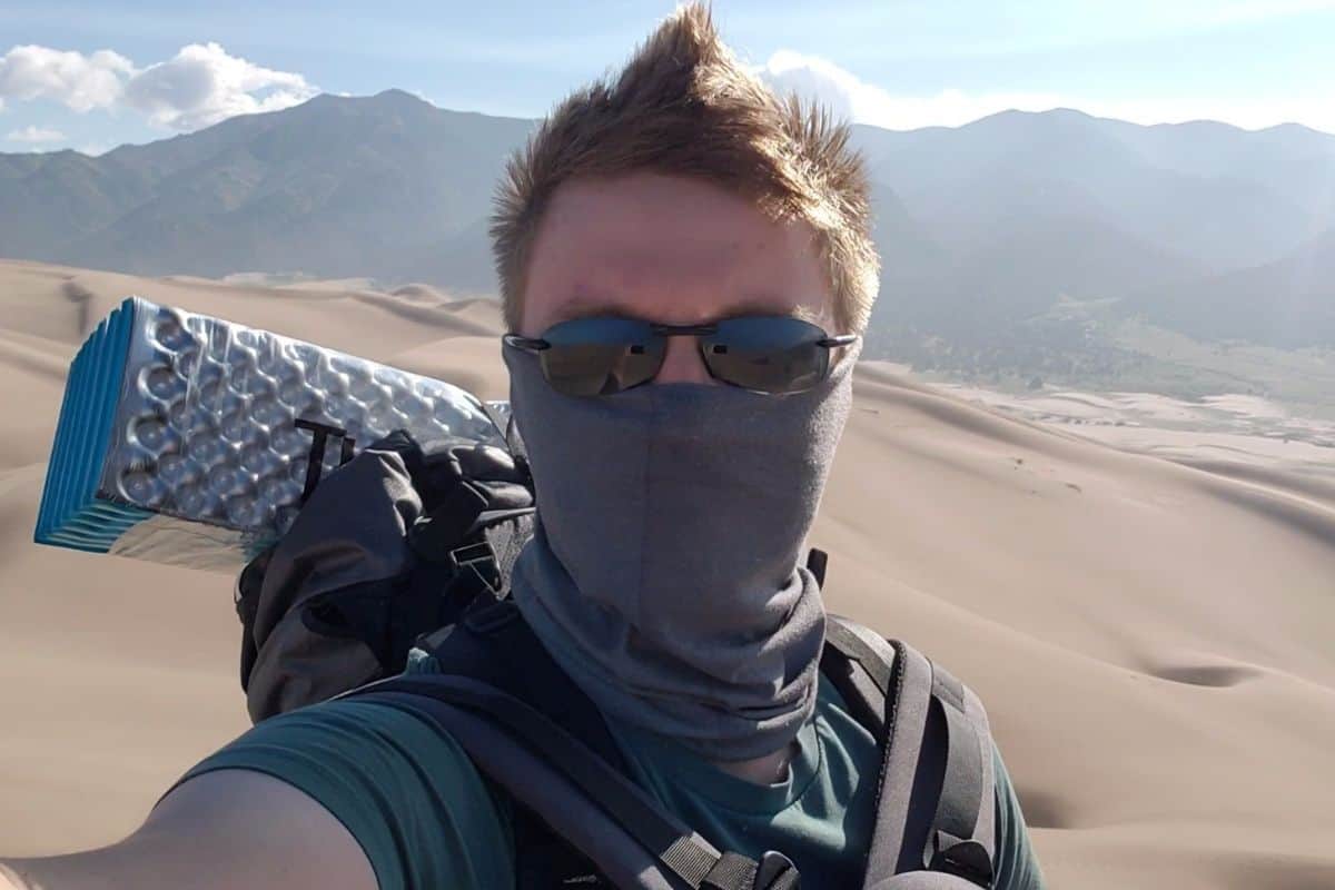 man wearing a face mask in sand dunes