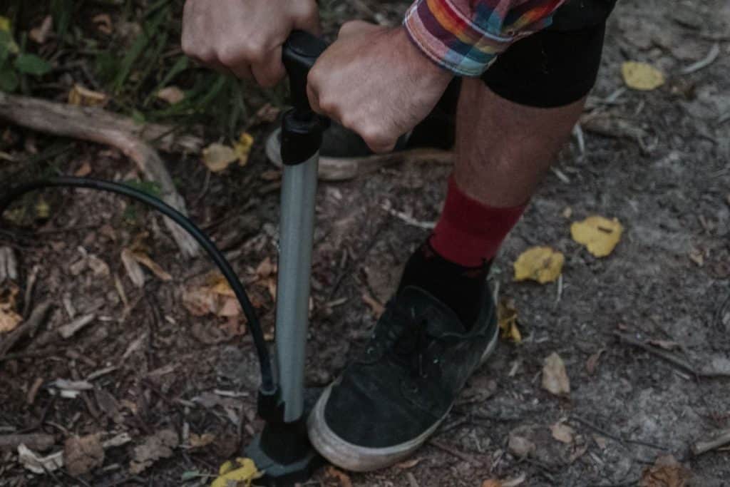 man using a hand pump