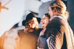 three women laughing outside