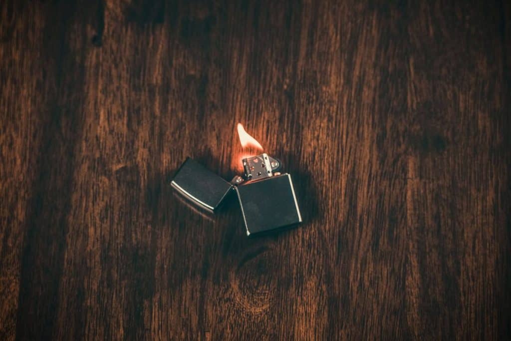 The Best Camping Lighter in 2023 1 lighter on a wooden table