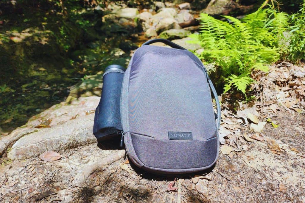 gray backpack on a rock in the forest