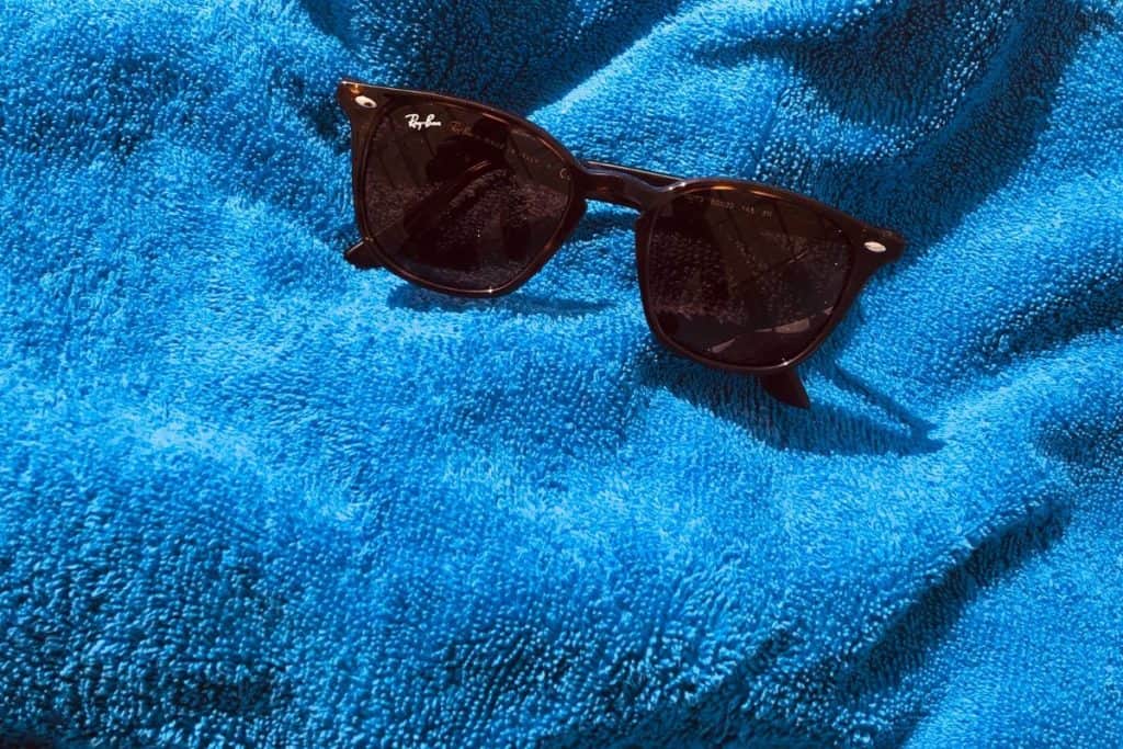 blue towel with brown sunglasses