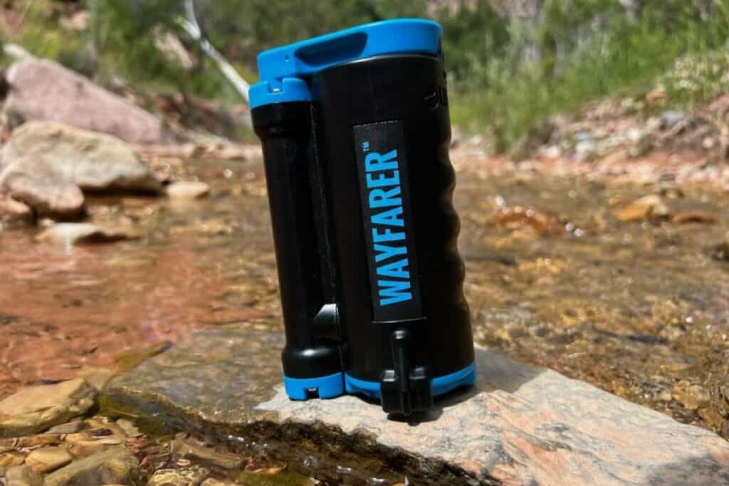 water pump filter on a rock in a stream