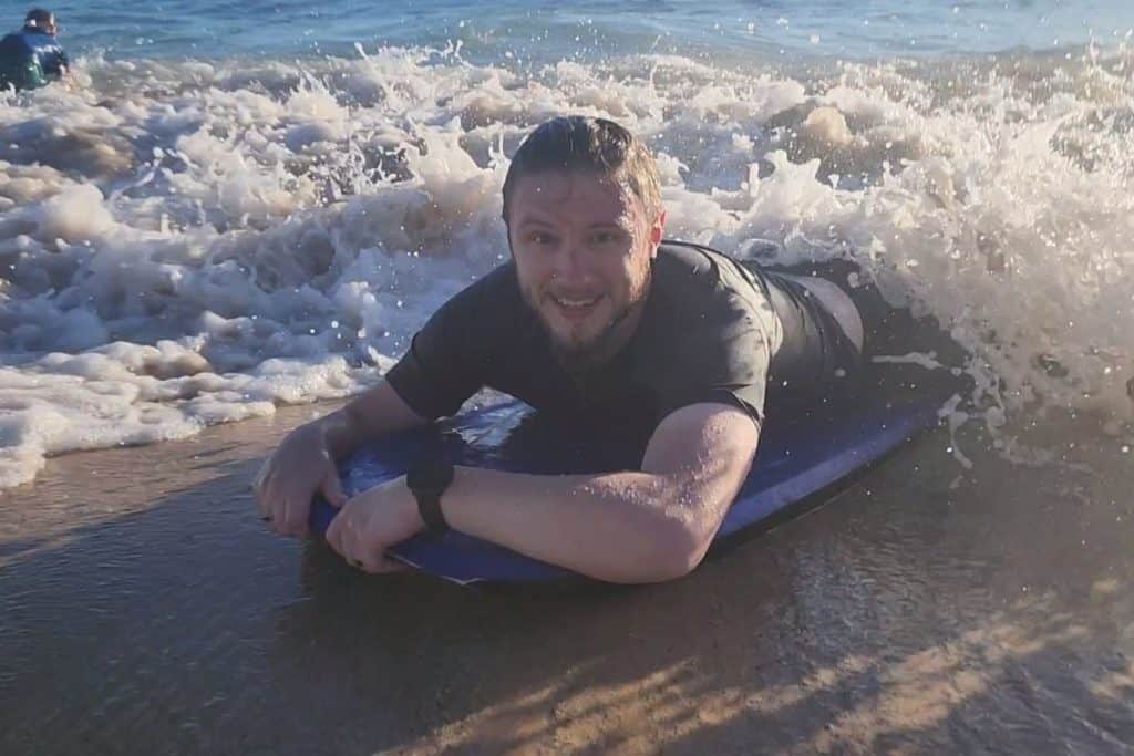 man on a boogie board on the beach