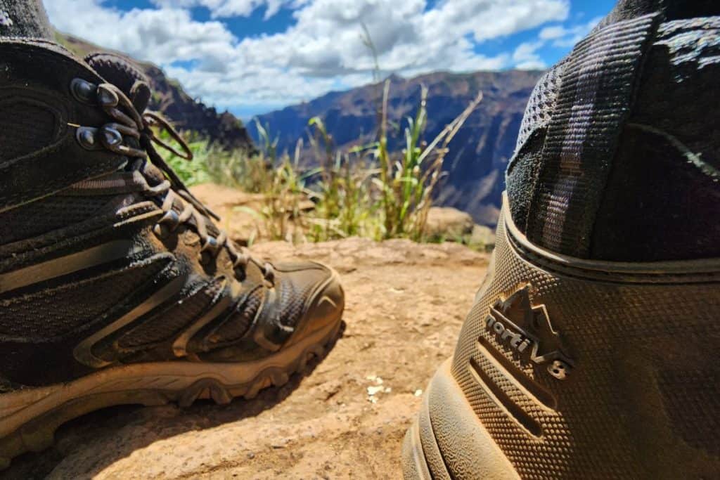 black boots on orange dirt in a canyon
