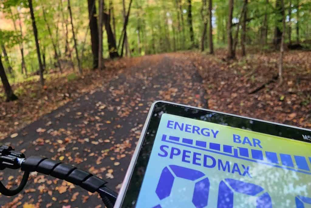 led screen on a scooter on a trail with leaves