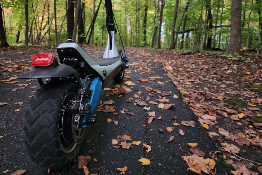 back scooter tire on a trail with fallen leaves