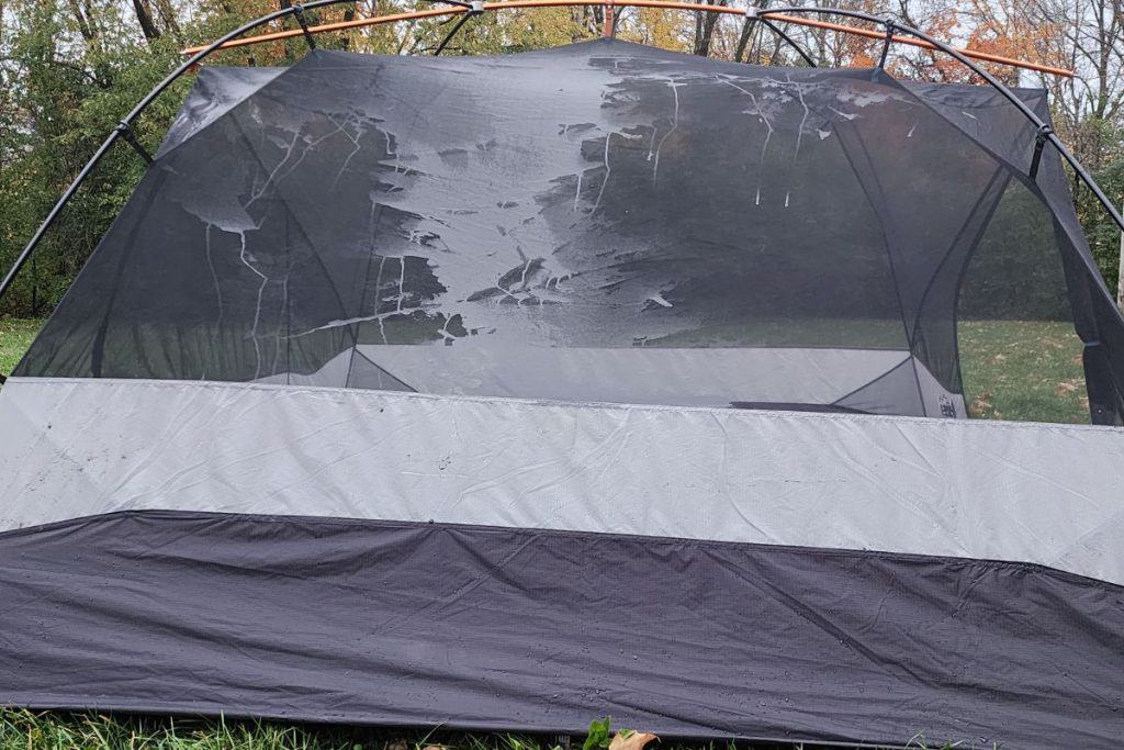 side of a tent with condensation buildup on the mesh