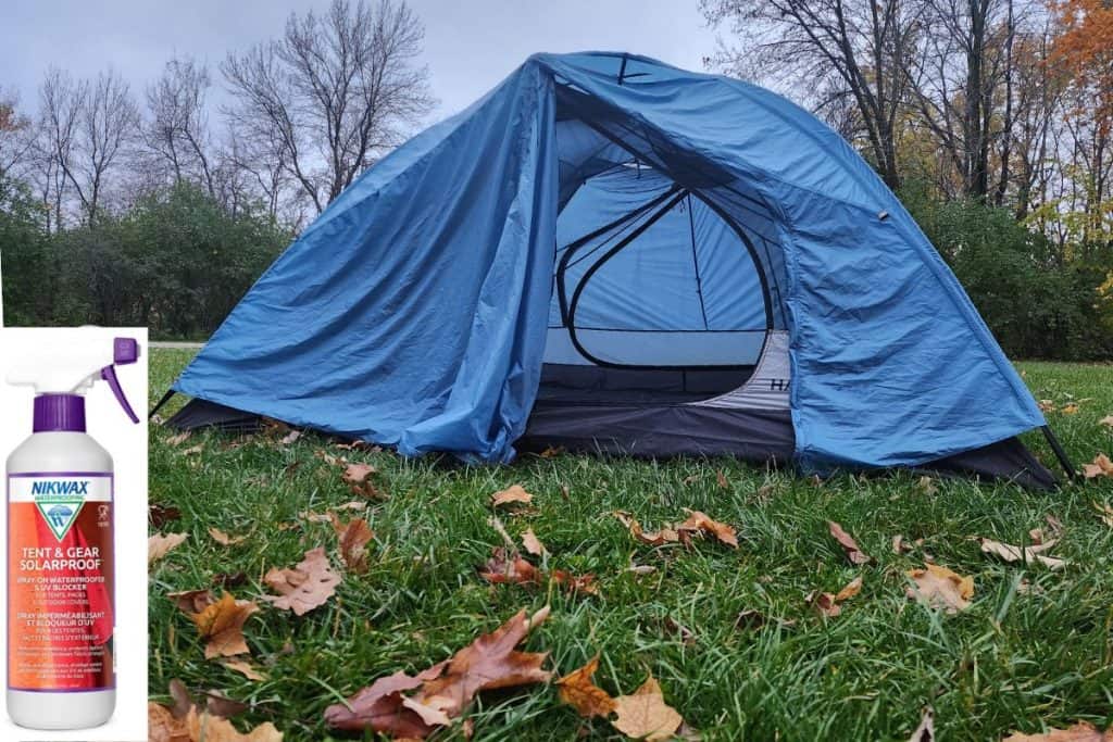 blue tent on grass with nikwax waterproofing spray