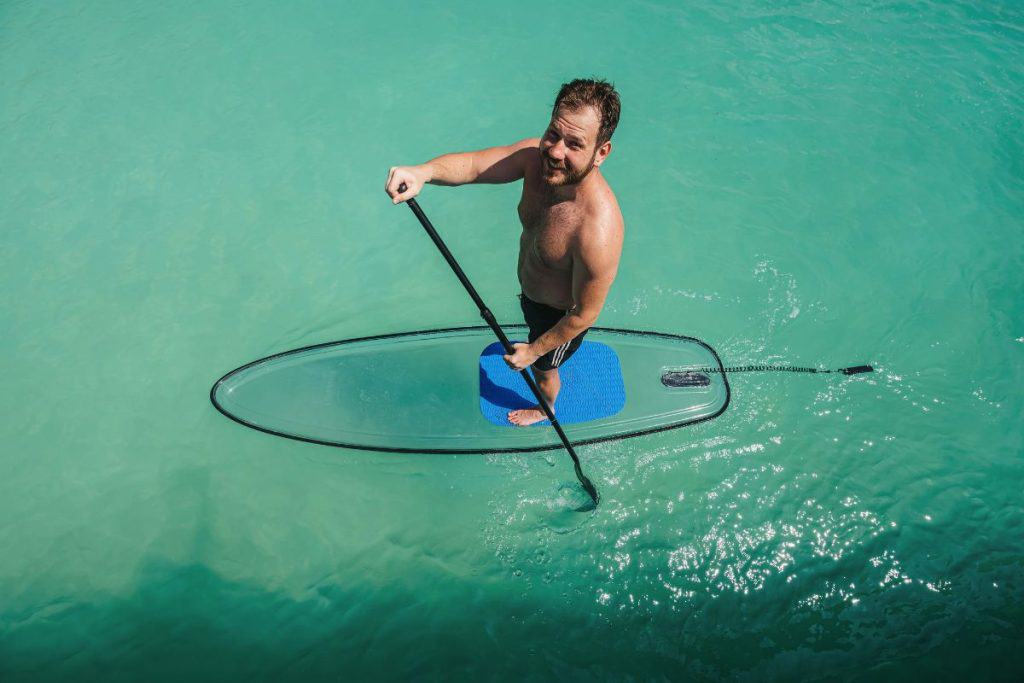 man standing on a paddleboard in the water