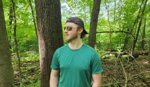 man wearing a green shirt in the forest